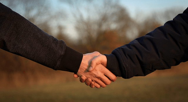 handshake after refinancing existing mortgage with our mortgage company, getting a new va loan with the same loan balance but a lower monthly mortgage payment