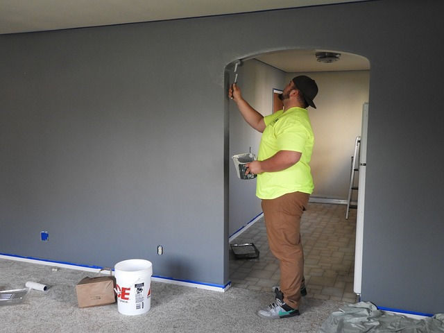 A man painting his room after refinancing his current loan with West Coast Veterans mortgage lenders.